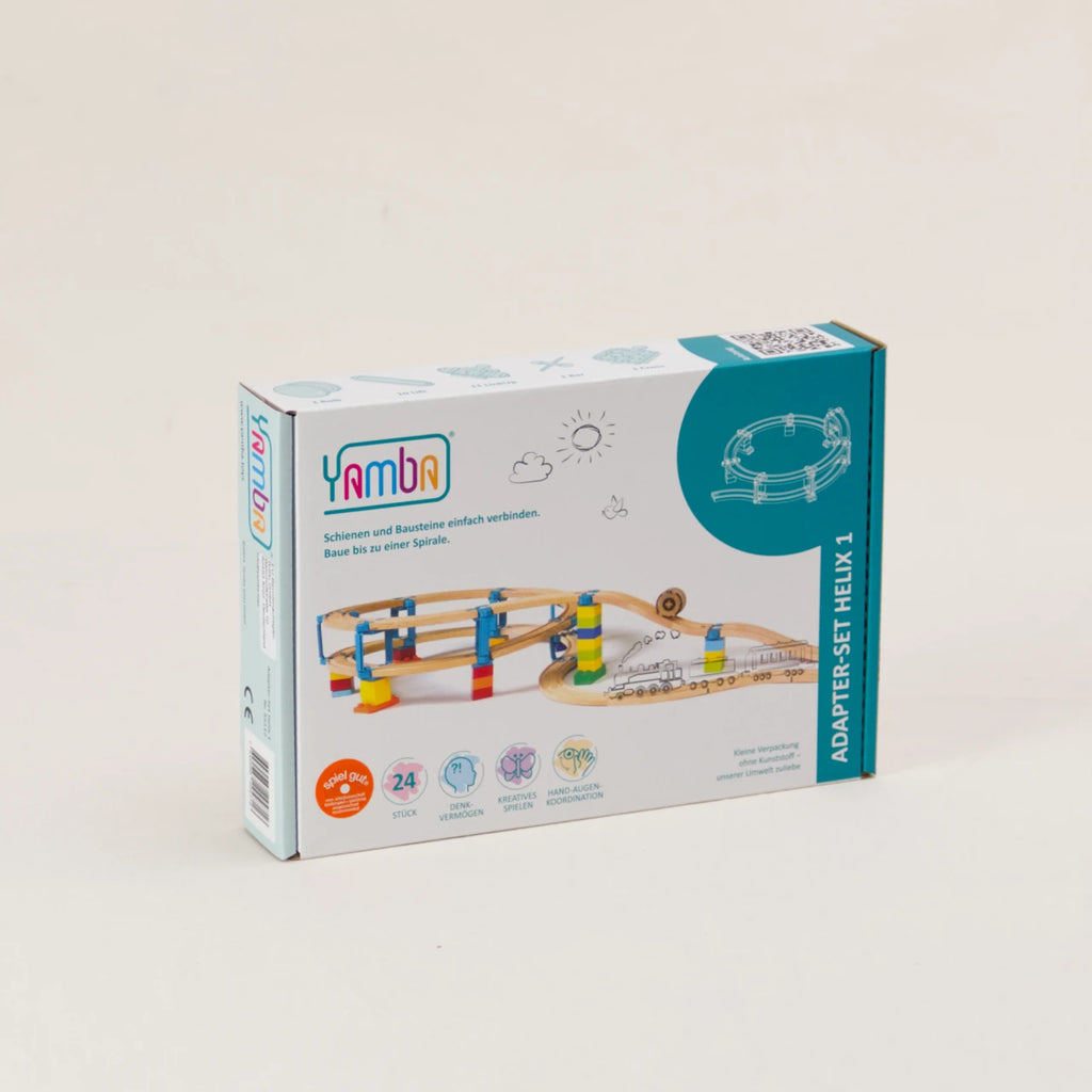 Zu sehen ist die Verpackung des Adapter-Sets Helix 1 von Yamba. Die rechteckige Pappverpackung ist weiß und türkis mit bunten Details und zeigt einen möglichen Aufbau. Die Verbindungselemente ergeben zusammen mit Klemmbausteinen (DUPLO®, BioBUDDi®, Hubelino® usw.) und Schienen (BRIO®, IKEA®, Eichhorn®, Hape® usw.) ein mehrstöckiges Säulensystem. Helix 1 ist das kleinste Paket und ermöglicht bereits zwei Schleifen nach oben.