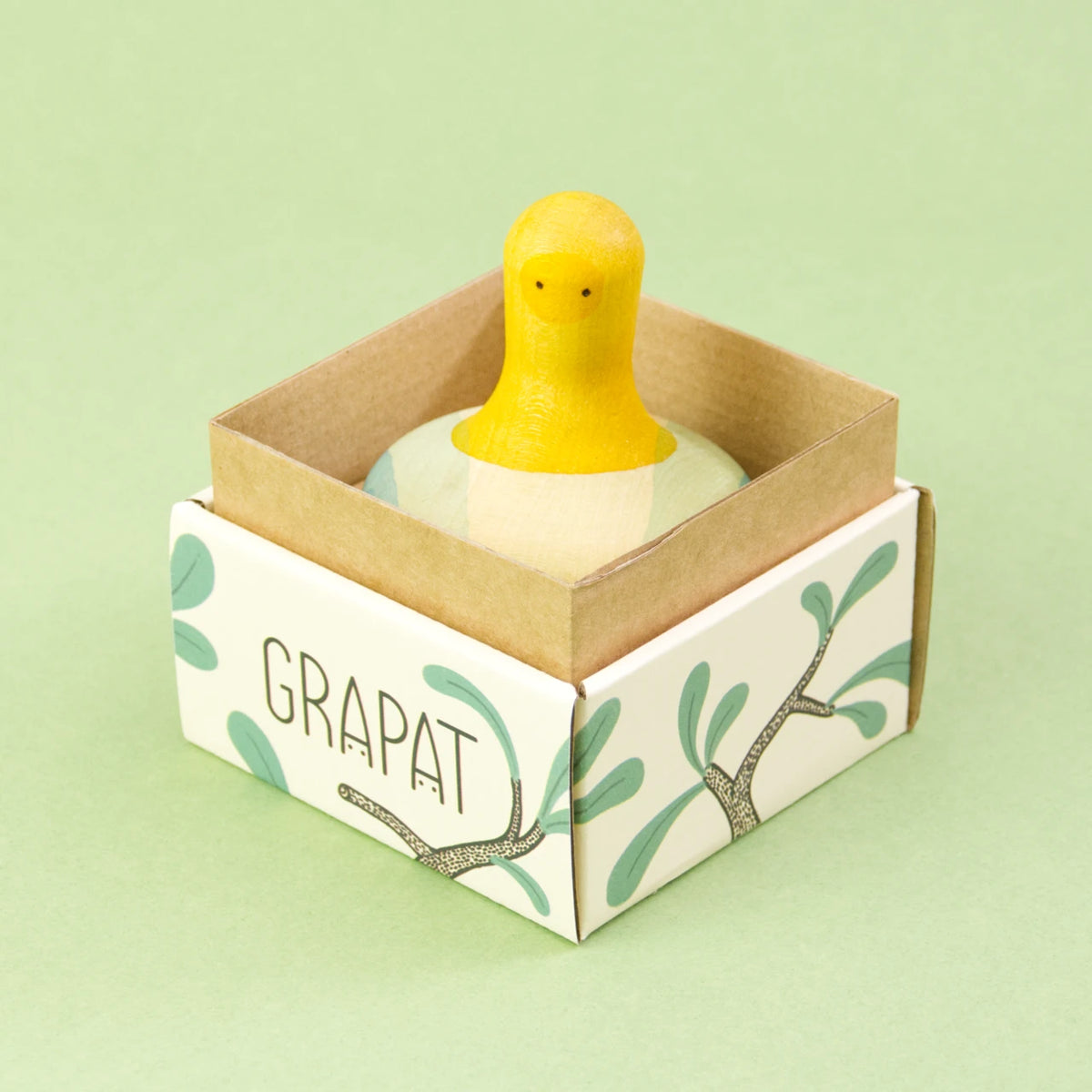 Flowing yellow bird von Grapat, in den Farben Gelb und Blautönen. Vorderansicht in der Verpackung.