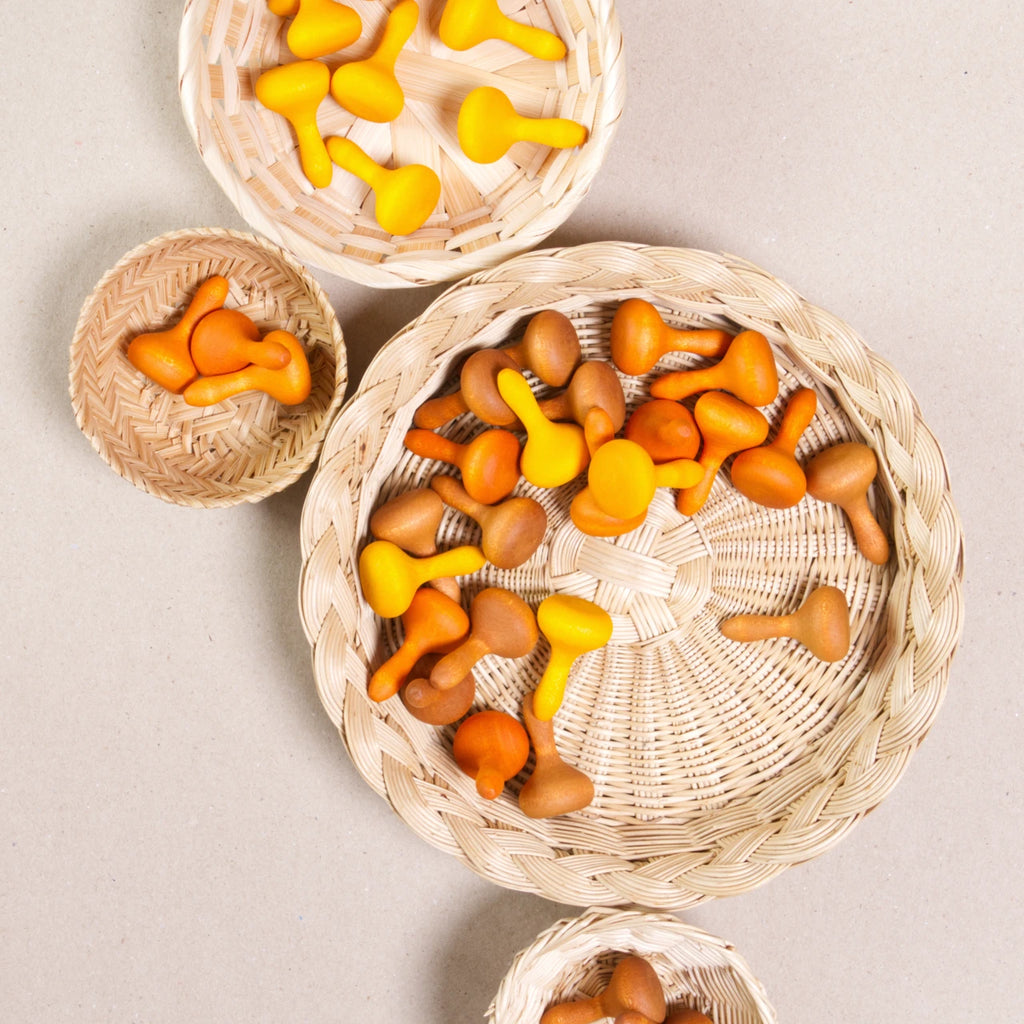 Komposition aus den Figuren aus dem Set Mandala pumpkin von Grapat. Alle Holzfiguren sind orange, braun und gelb. Alle sind in vier Körbchen aufgeteilt.