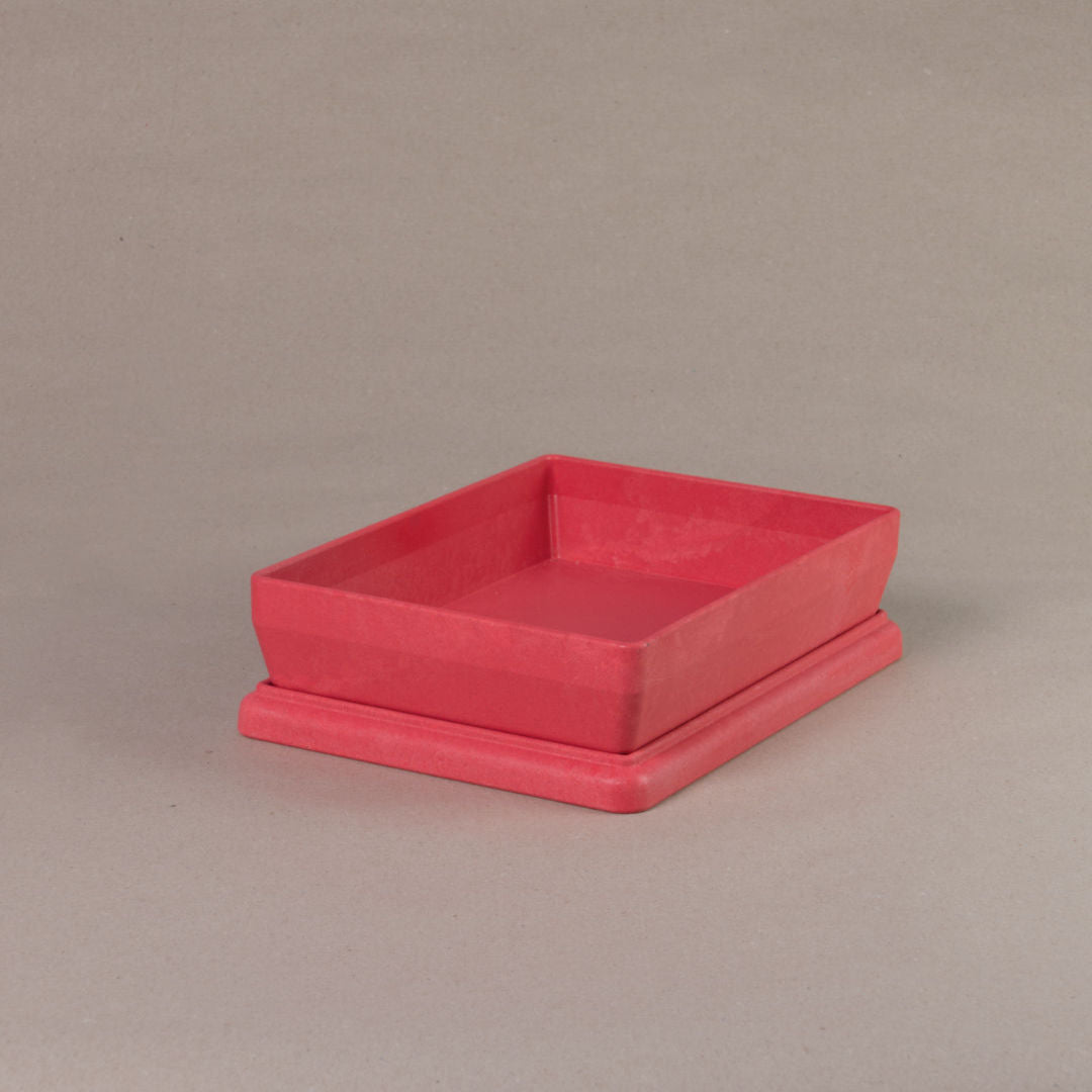 Die aus recyclebarem Material bestehende rote Box von Wissner, mit offenem Deckel daliegend.