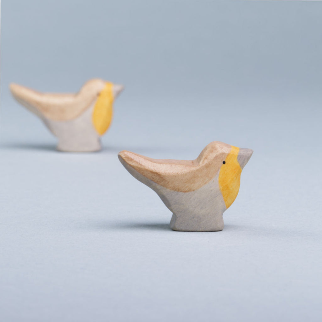 Zwei Rotkehlchen von Holzviecherl haben ein braun, orangenes Gefieder. Beide schauen nach rechts.