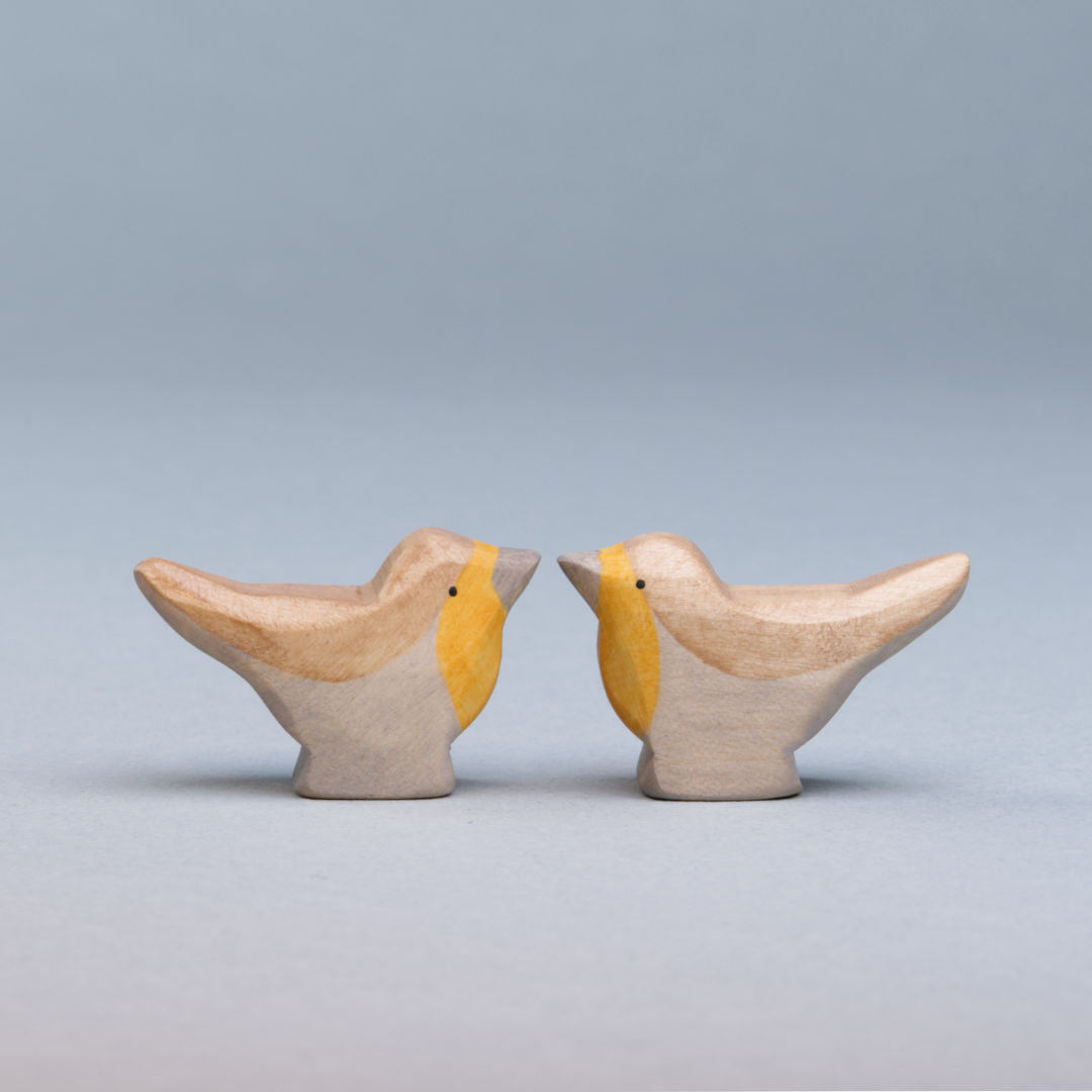 Zwei Rotkehlchen von Holzviecherl haben ein braun, orangenes Gefieder. Beide schauen sich gegenseitig an.