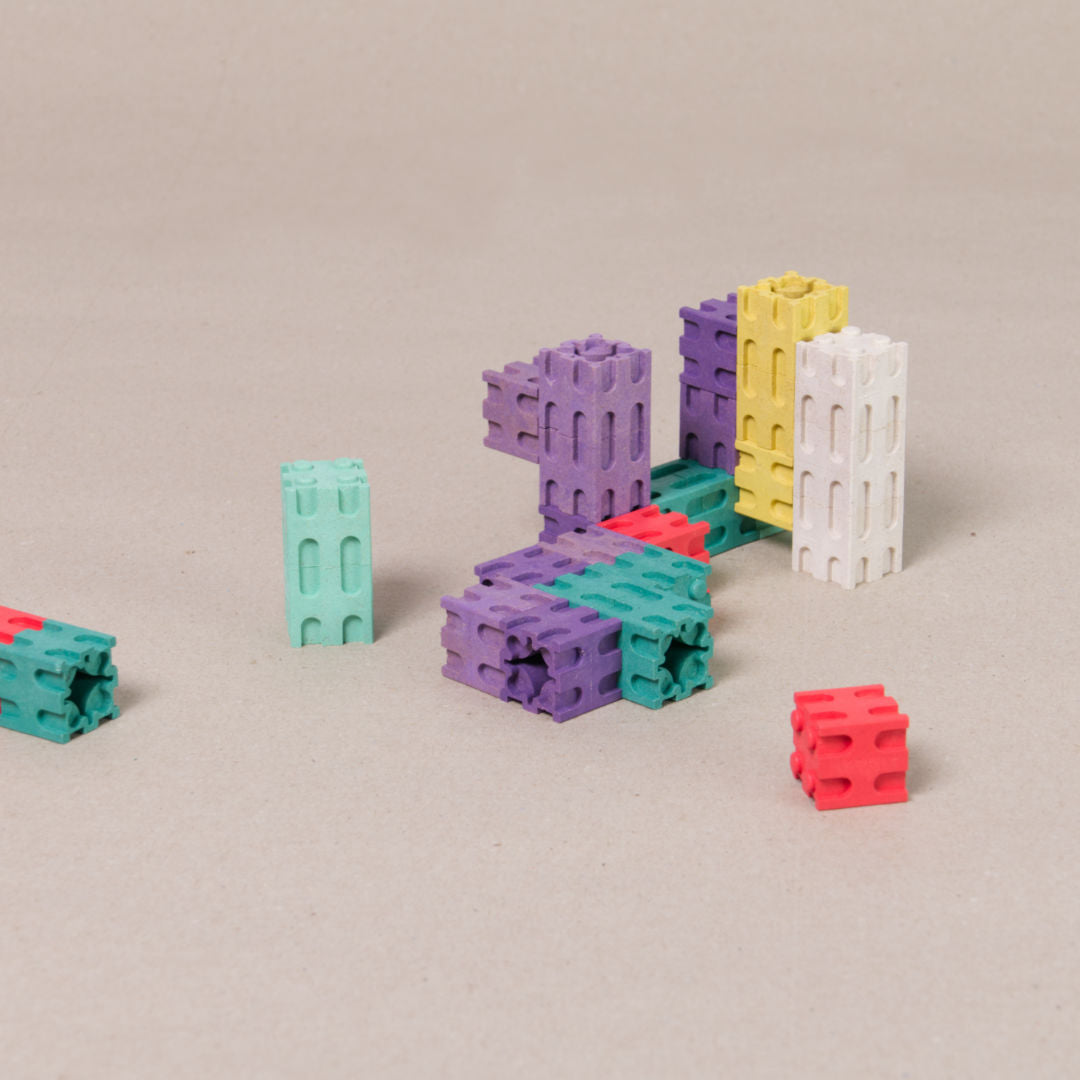 Komposition mit dem 100 teiligen Steckwürfel Set von Wissner. Enthalten sind die Farben grün, gelb, lila, rot, türkis und weiß.