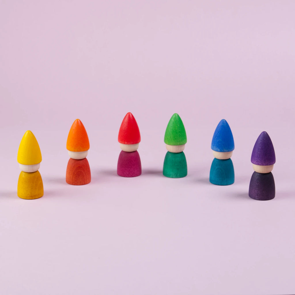 Sechs Figuren mit einer spitzen Mütze von Grapat hergestellt sind mit nach vorne hin geöffnetem Halbkreis geöffnet zu sehen. In gelb, orange, rot, grün, blau und lila.