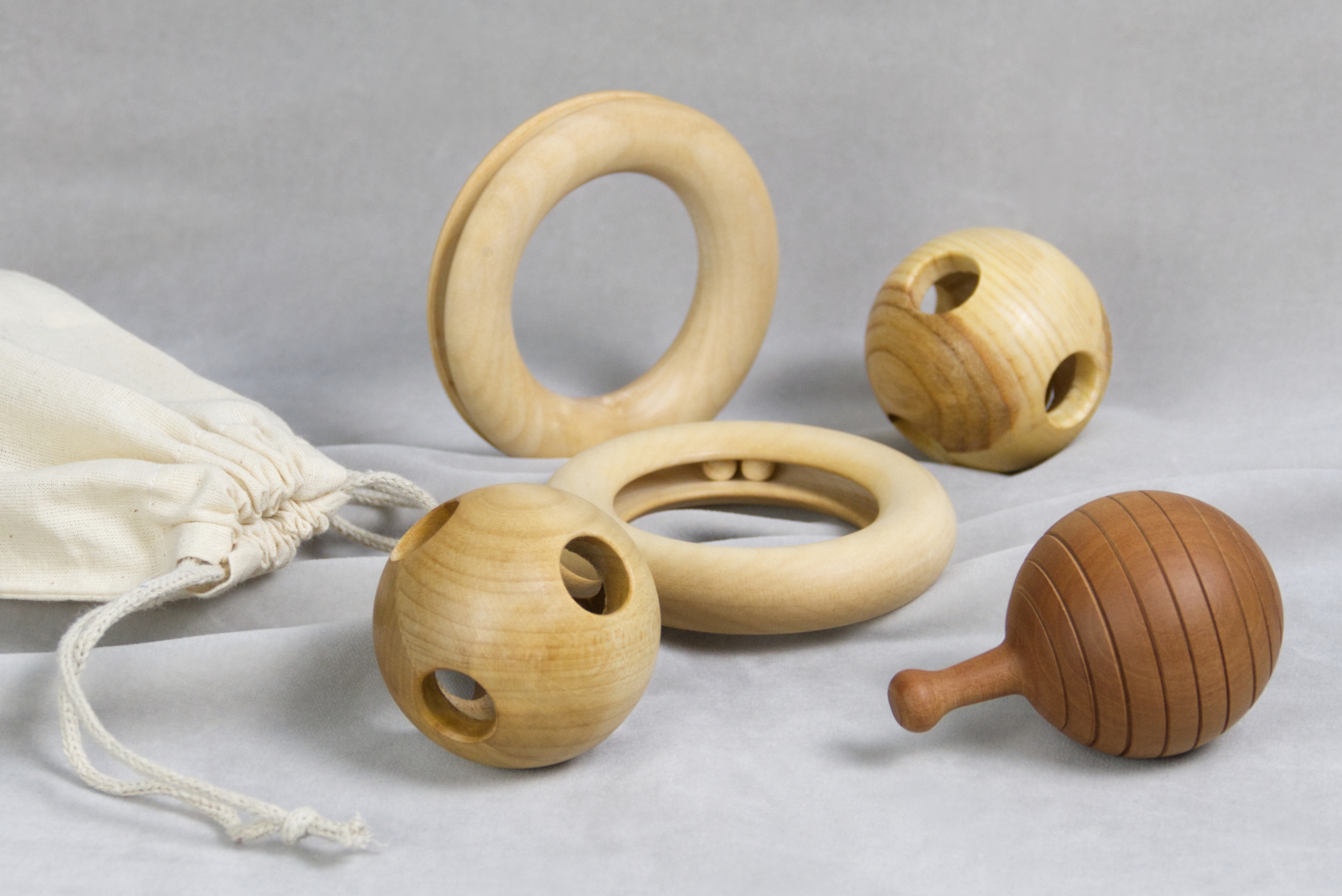 Komposition aus Greiflingen für Babys in Kugel- und Ringform mit Baumwollsäckchen