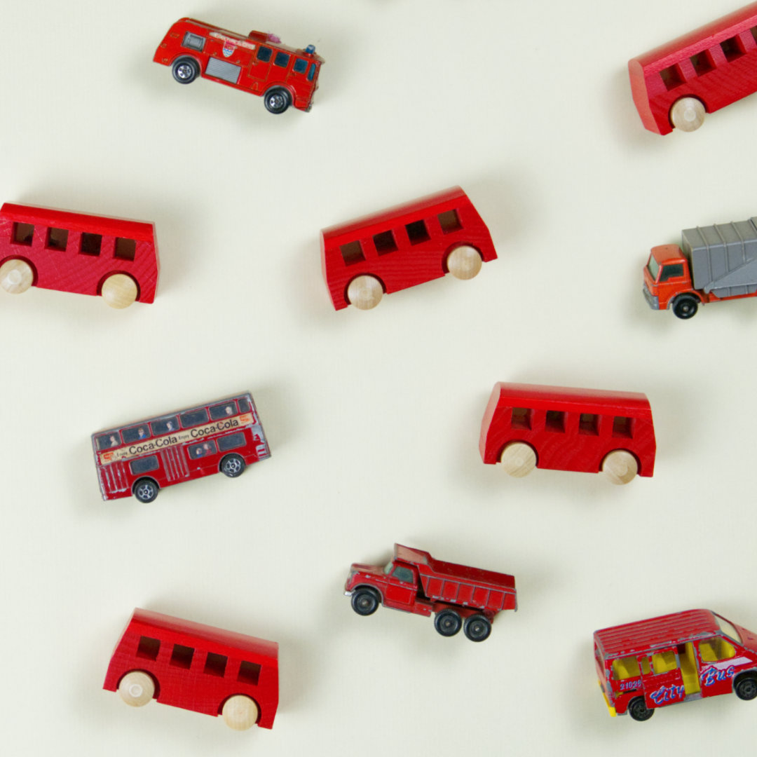 Komposition von roten Spielzeugbussen, Feuerwehrautos und LKWs zum Spielen
